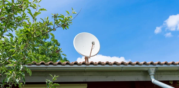 Satellite dish alignment by skilled technicians for optimal TV viewing experience.